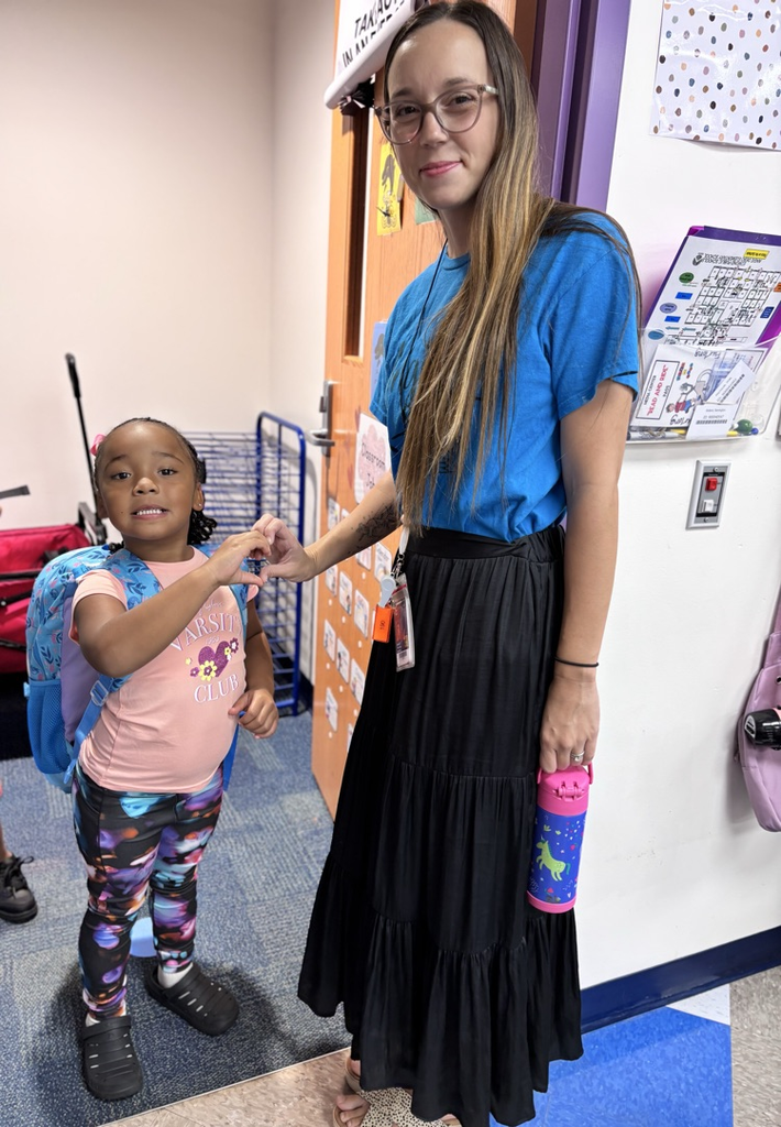 blue team student and Mrs. Furlong greeting each other 