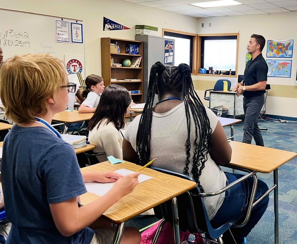 Mr. Faulkner instructs 6th grade students in his classroom.