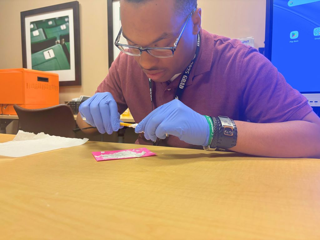 intern spreading toothpaste on paper