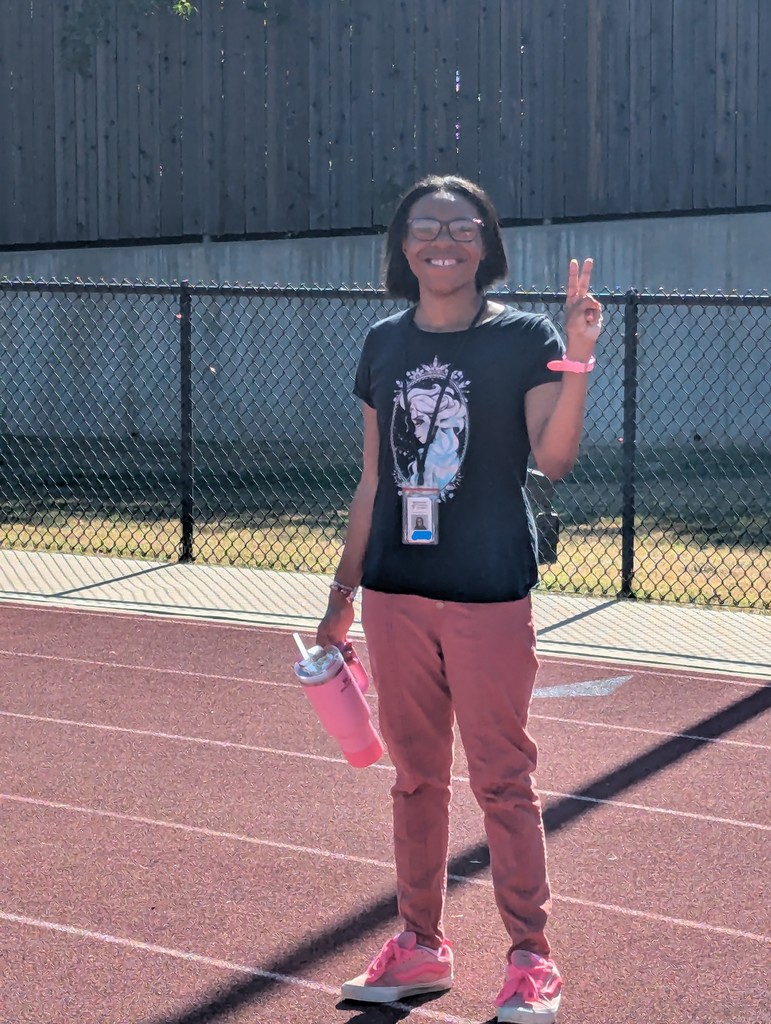 intern smiling while standing on the track