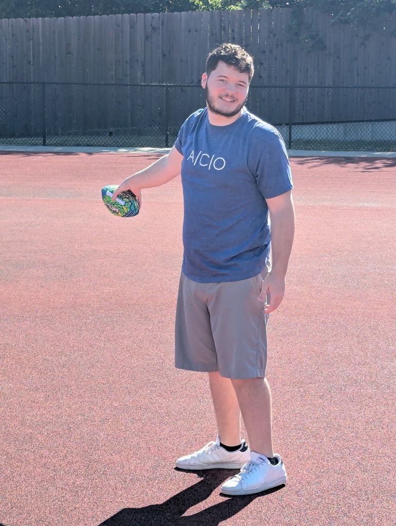 intern holding a football