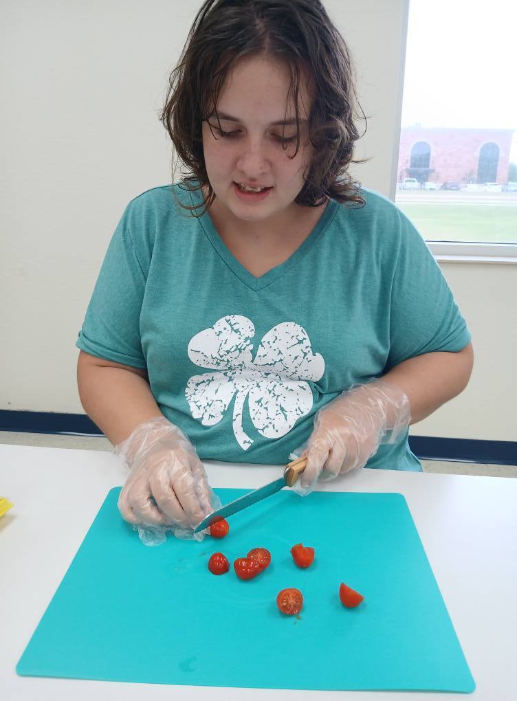 an intern cutting tomatoes