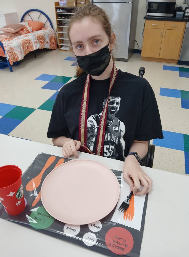 an intern setting the table