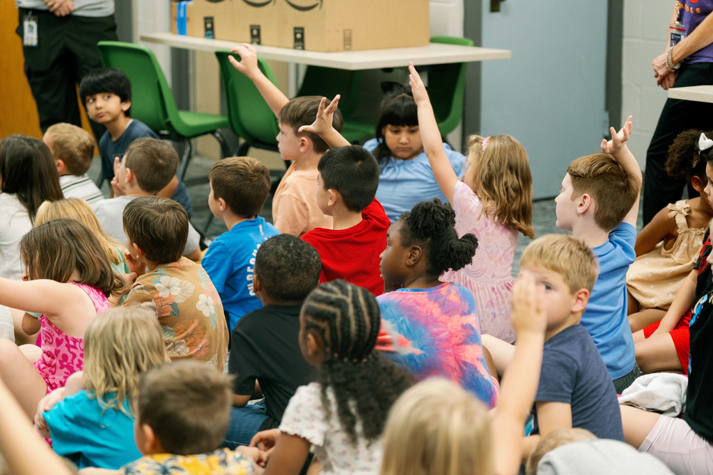 kids raising their hands