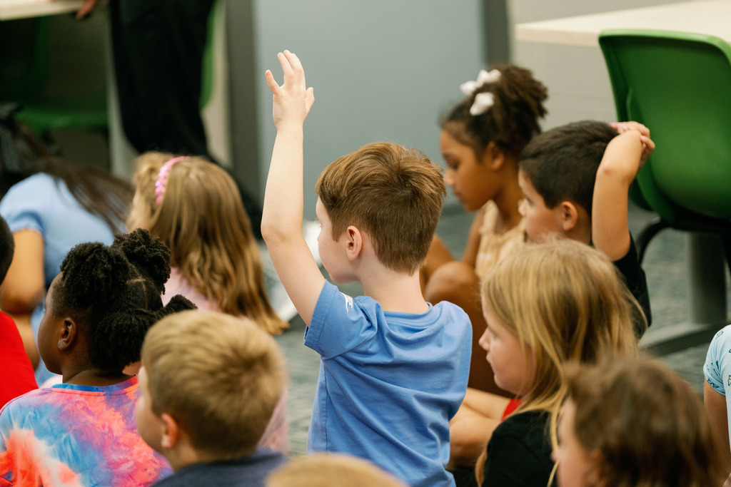 kids raising their hands