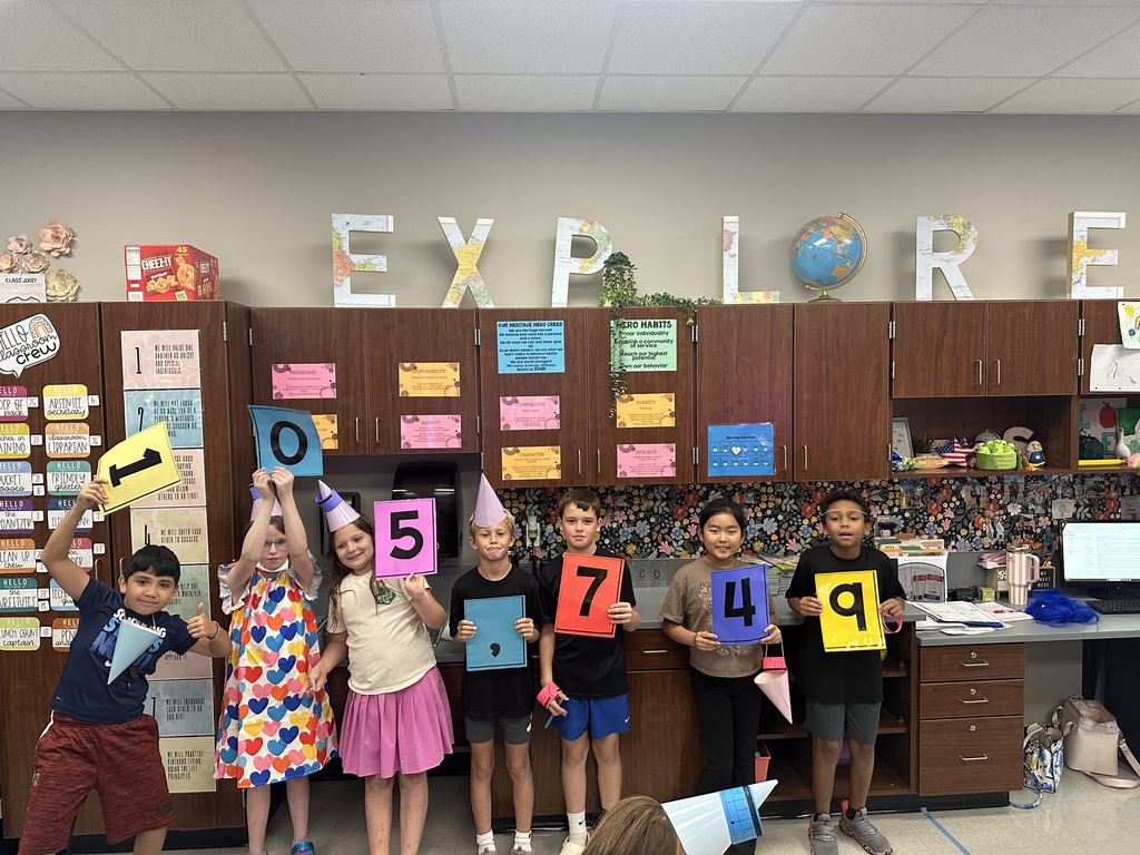 Kids holding numbers up with party hats