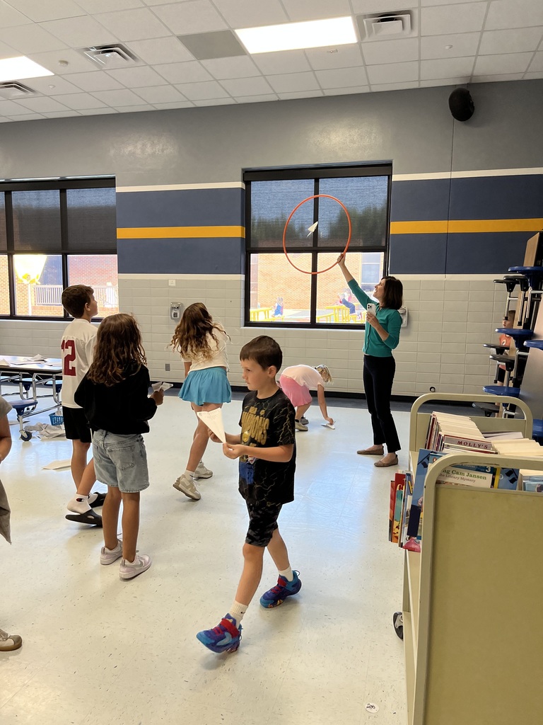 Clegern readers testing paper airplanes.