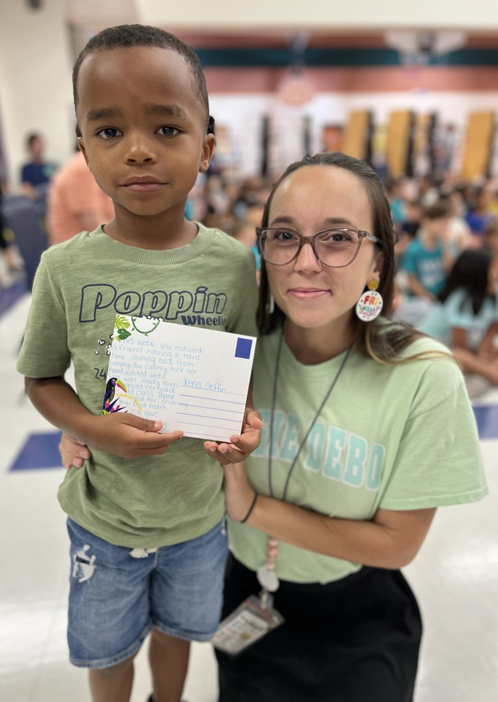 student and teacher with postcard