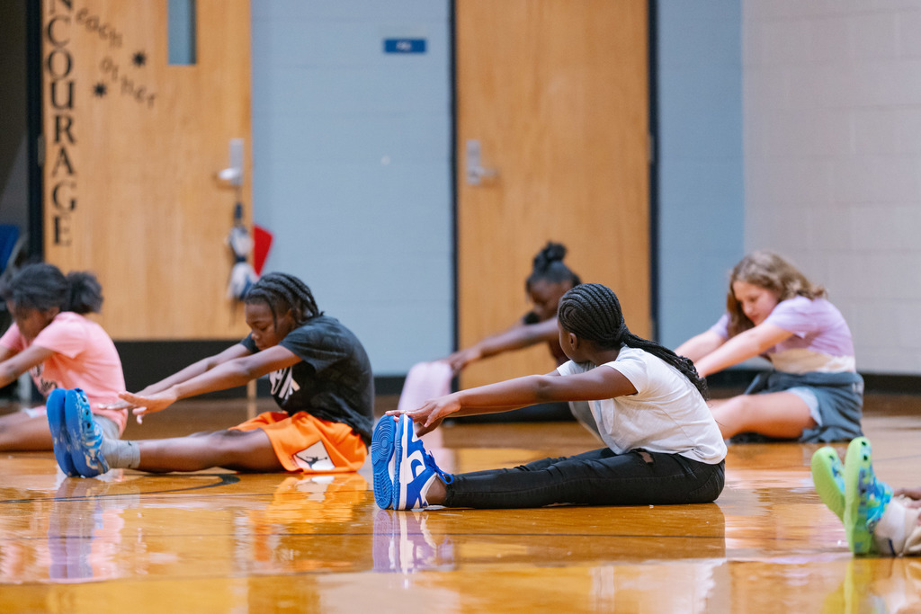 students stretching in gym class