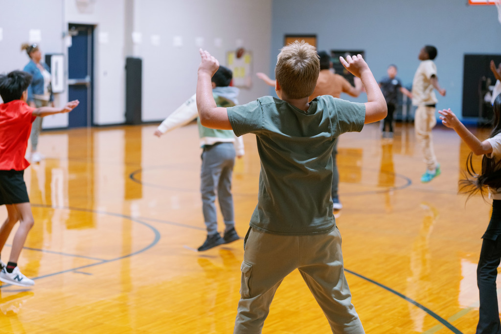 students stretching in gym class