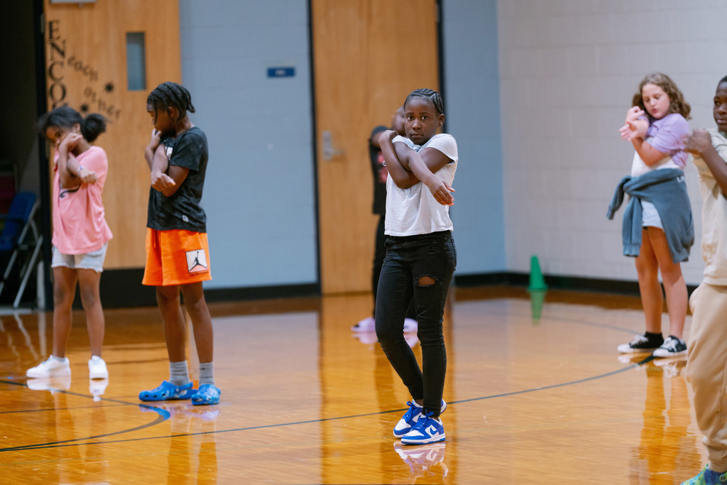 students stretching in gym class