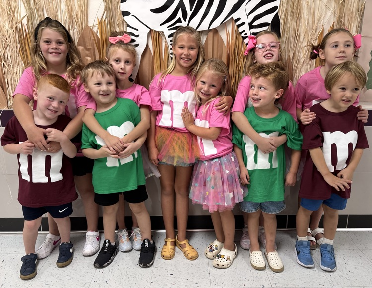first graders dressed as m&ms with their prek siblings dressed as m&m's