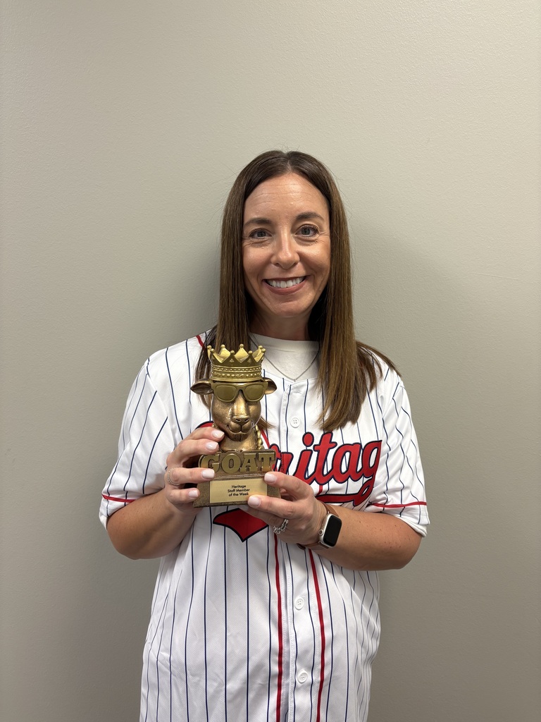Teacher in a jersey holding a trophy