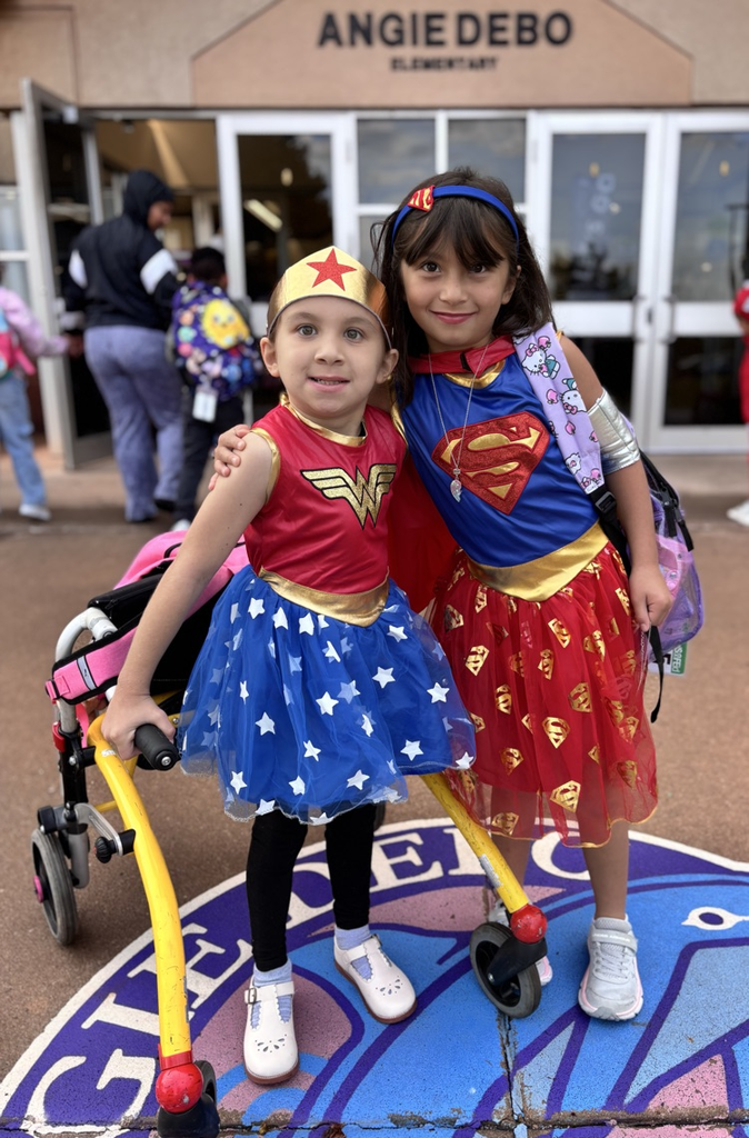 girls dressed up as wonder woman and super woman 