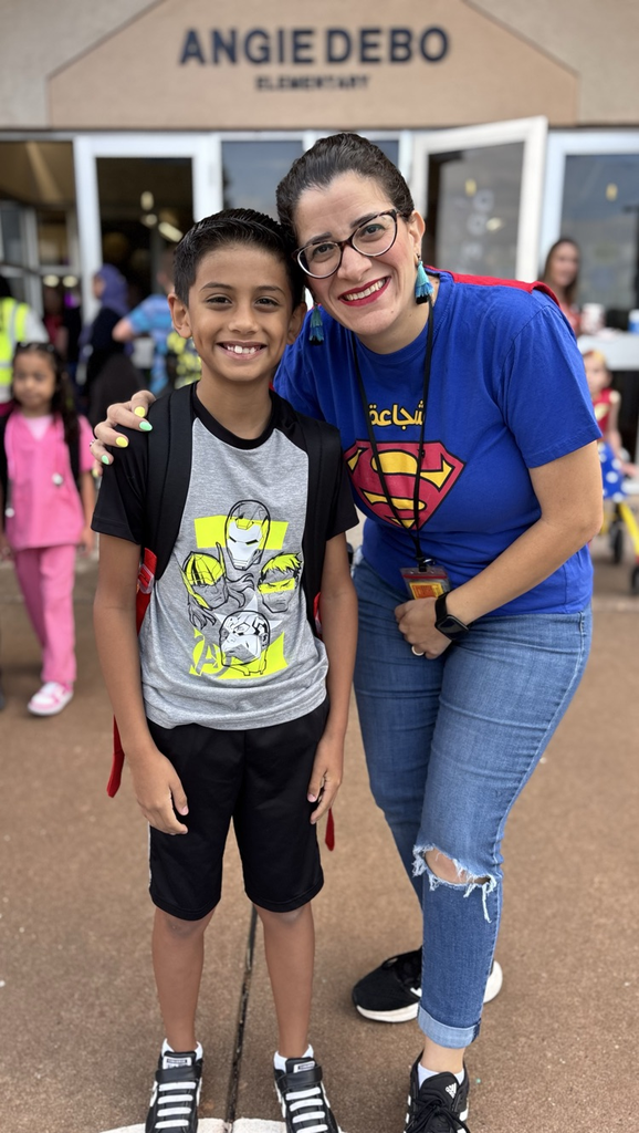 student and teacher dressed in hero gear 