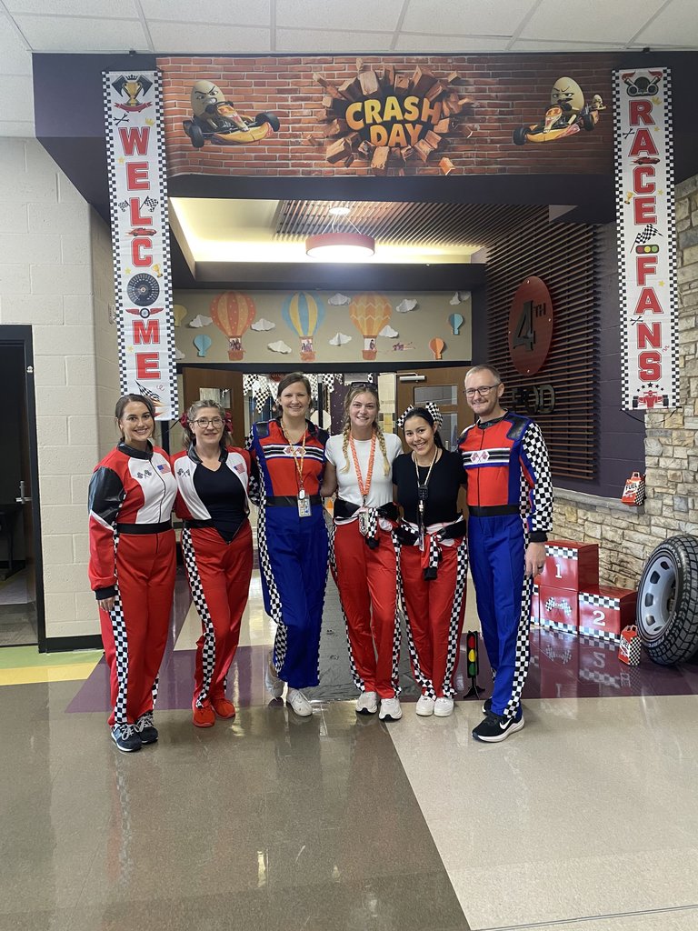 6 4th grade teachers standing in front of pod that's been transformed into a race track day