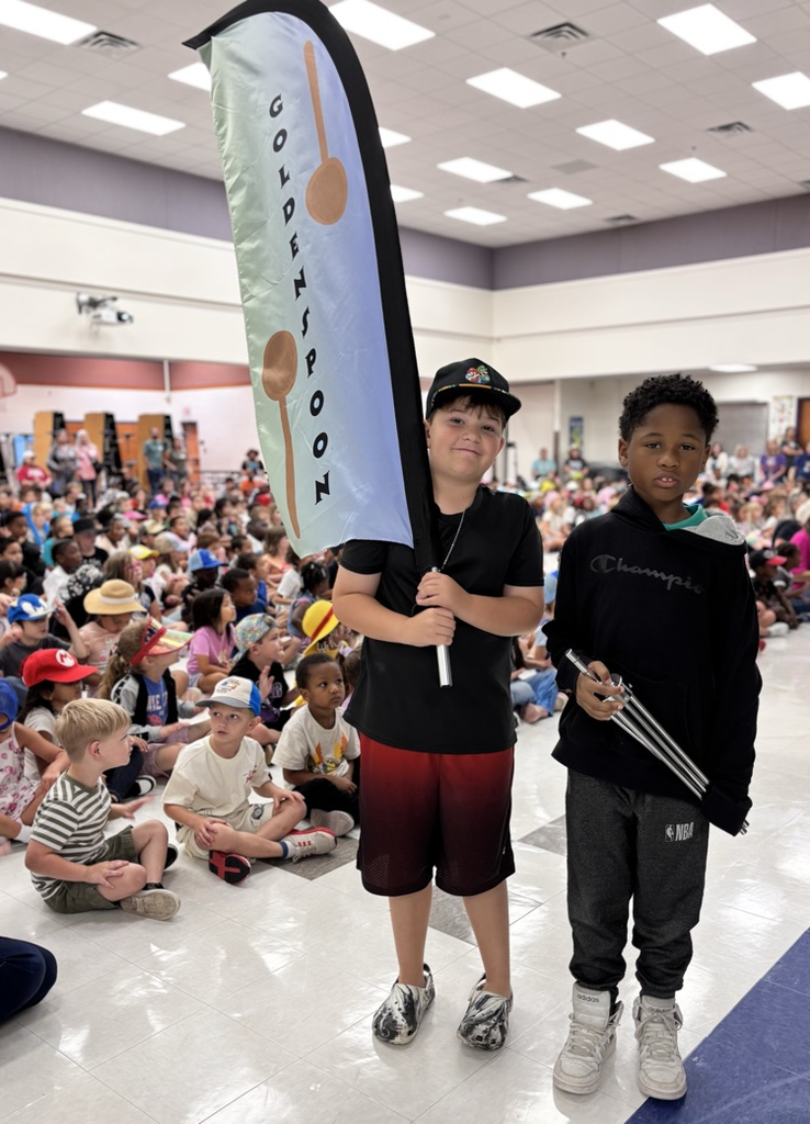 students holding golden spoon flag