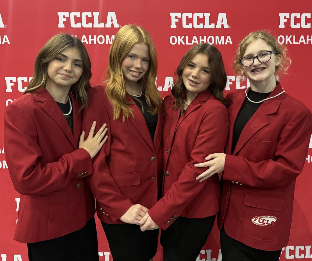 FCCLA officers are pictured smiling in front of an FCCLA Oklahoma sign at the Lead Conference they attended.
