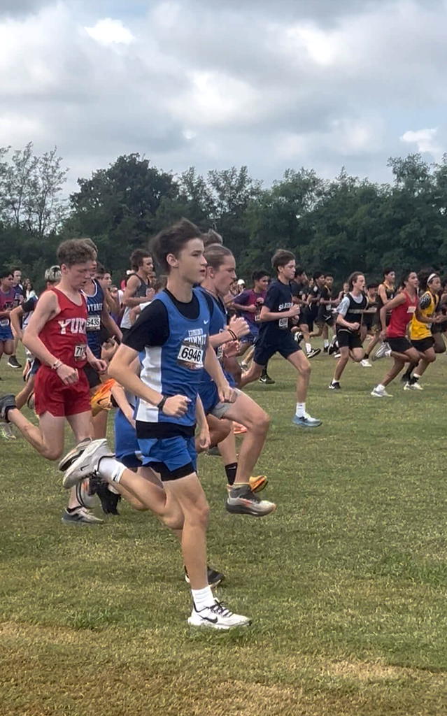 8th grade boys cross country athletes running at a meet.