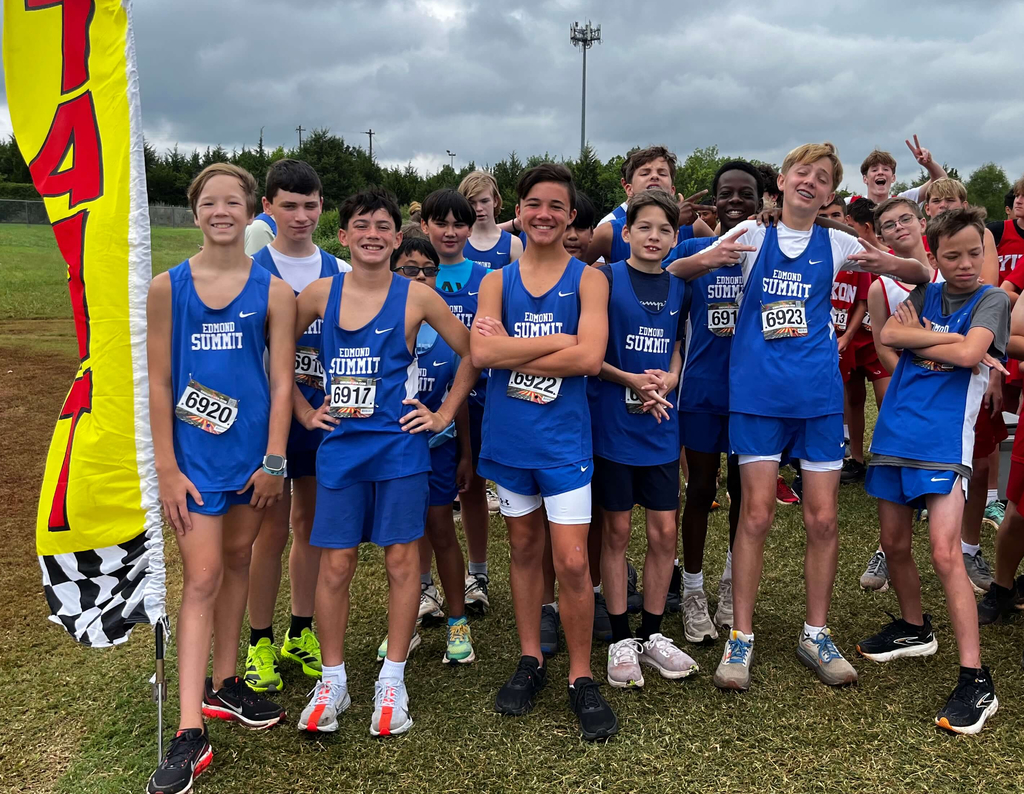 7th grade boys cross country athletes pictured standing together and smiling.
