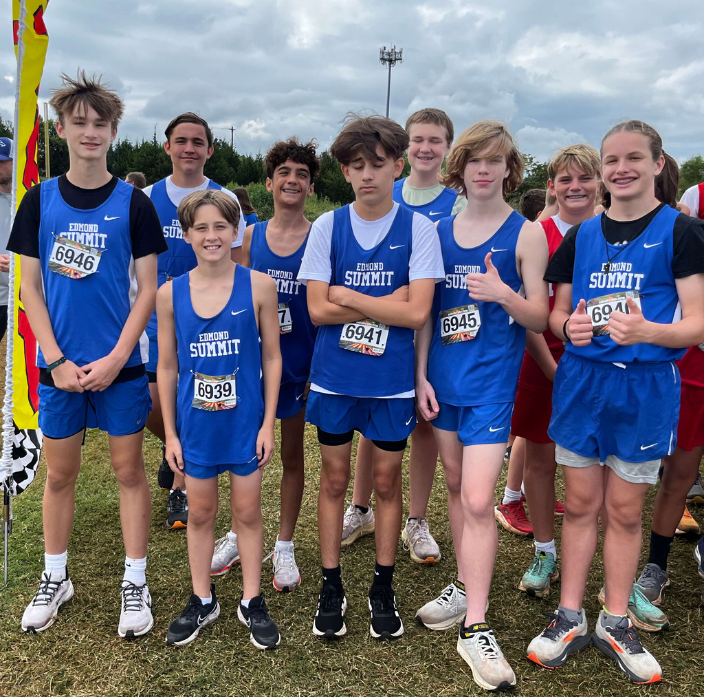 8th grade boys cross country athletes pictured standing together and smiling.
