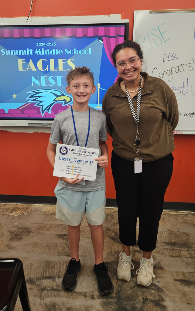 Ms. Sharp stands next to the student she nominated for Eagle's Nest.