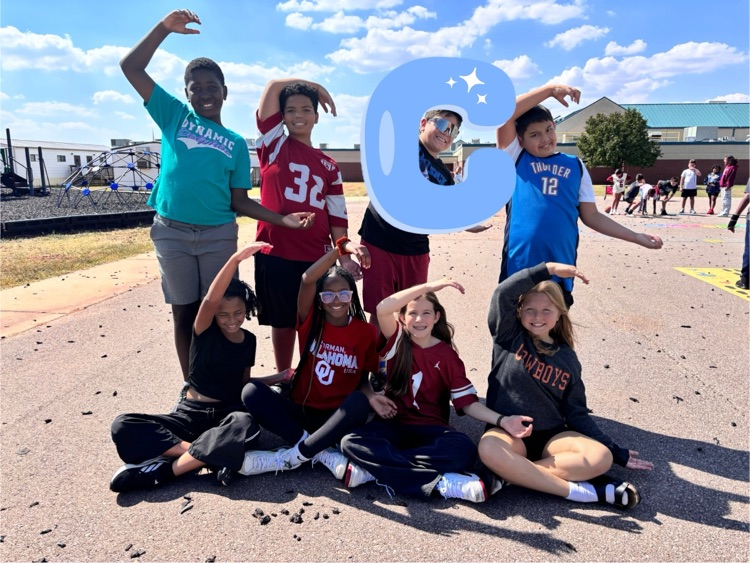 fifth grade students making the letter c with a c graphic over one student 