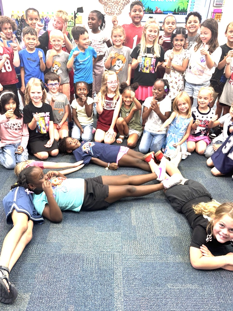 first grade students making the letter a 