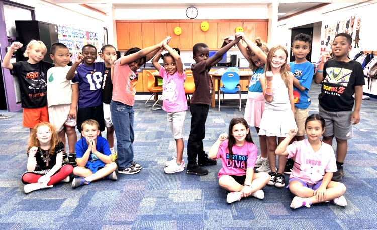 second grade students making the letter m 