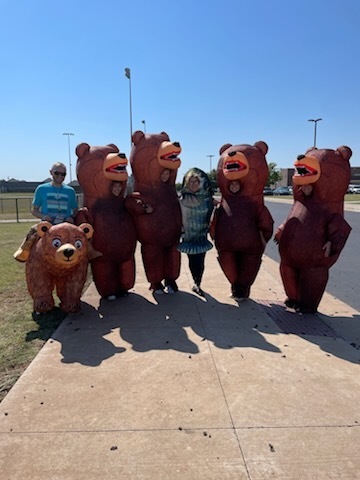 teachers in inflatable bear and fish costumes