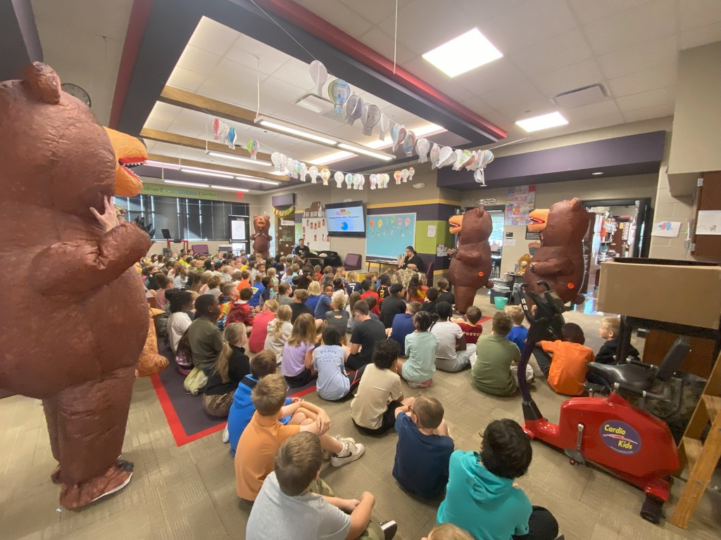 guest speaker with students and teachers in inflatable bear costumes