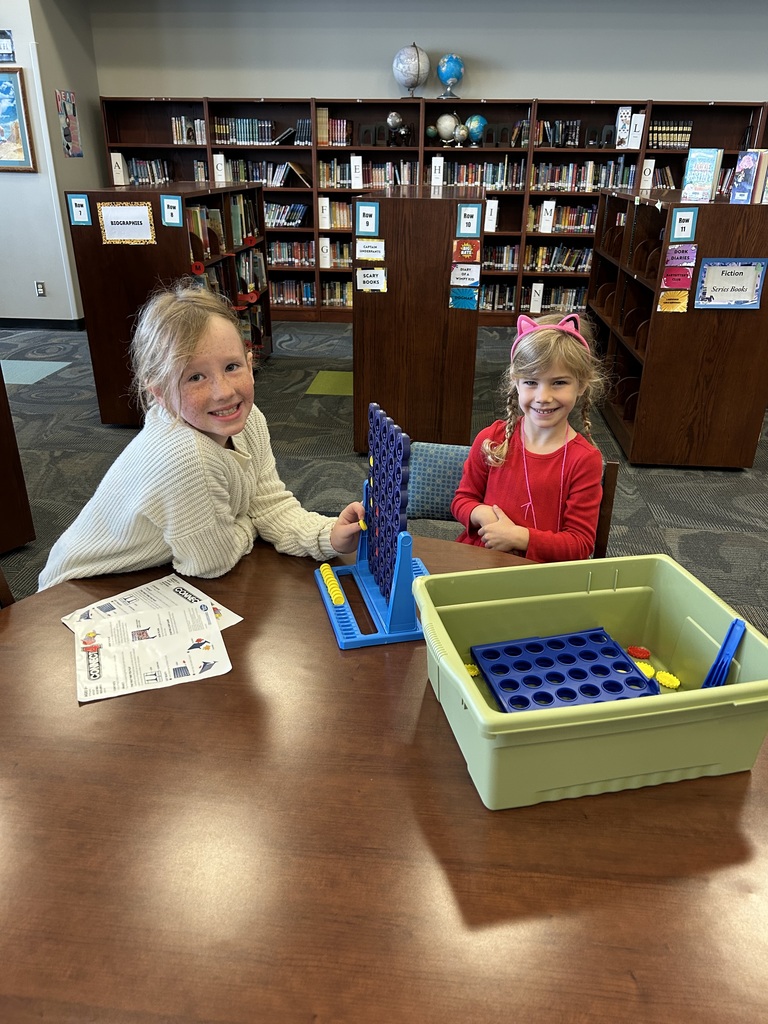 Kids at table playing connect 4