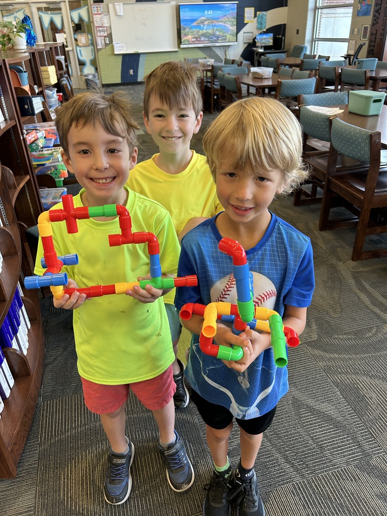 Two kids smiling with connection toys
