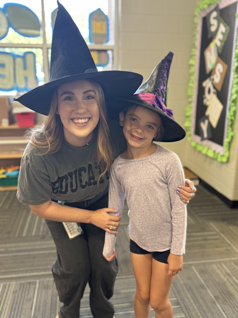 An adult and kid in witch hats