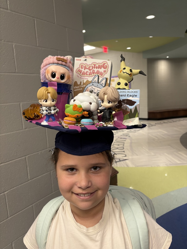 Student with hat that is covered in dolls