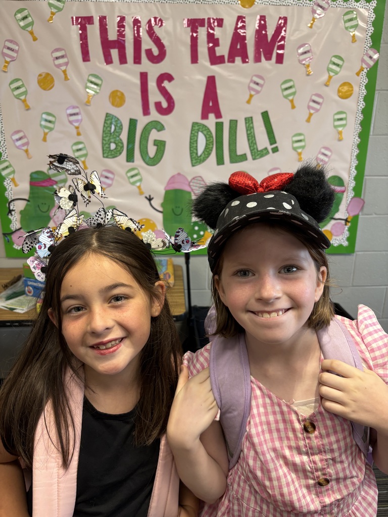 Two students, one with butterfly hat and other with mickey mouse hat