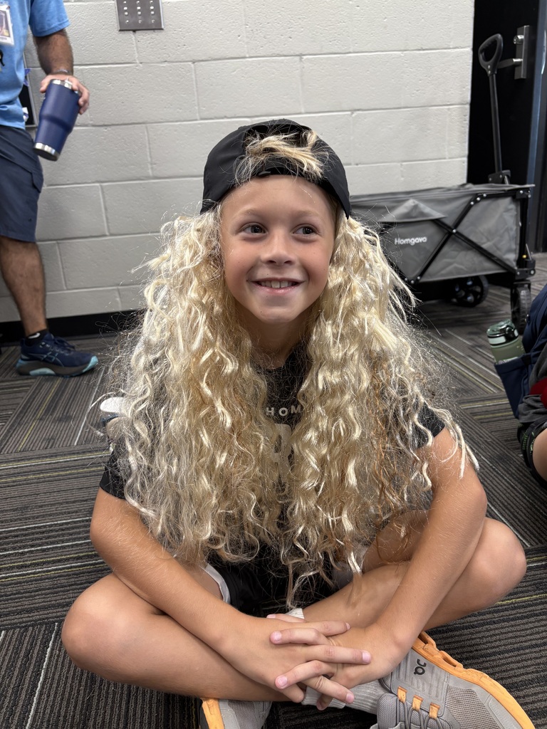 Student with long haired wig and hat