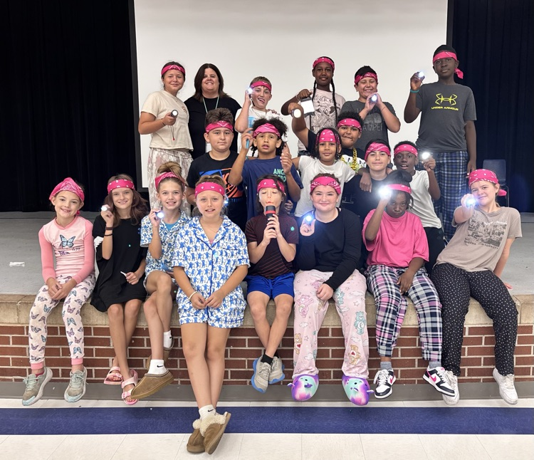 Mrs Hale’s fifth grade class on the stage with their flashlights 