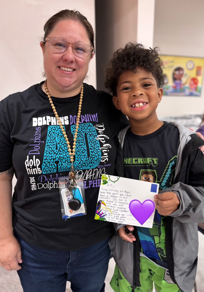student with mrs hopson getting a postcard 