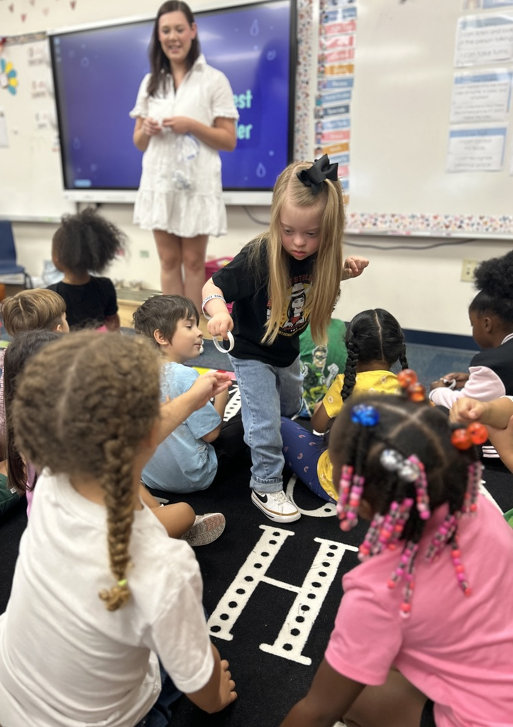 students passing out bracelets 