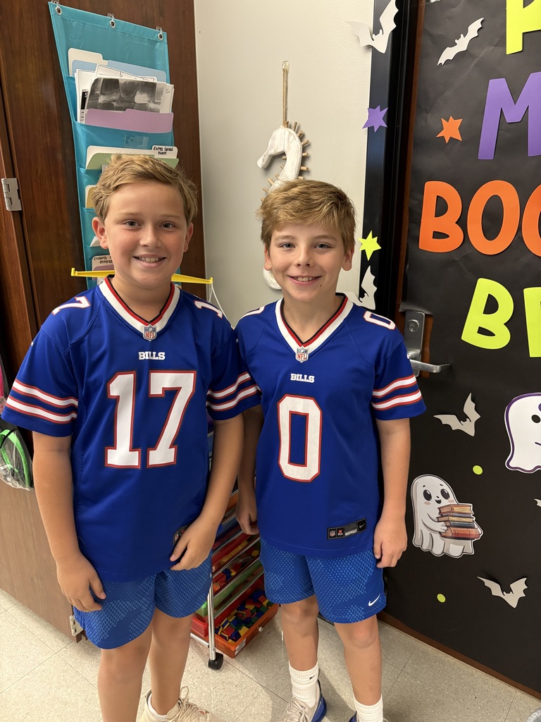 Two boys in matching outfits smiling