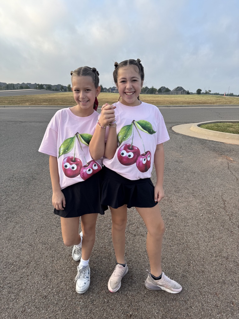 Two girls in matching outfits smiling