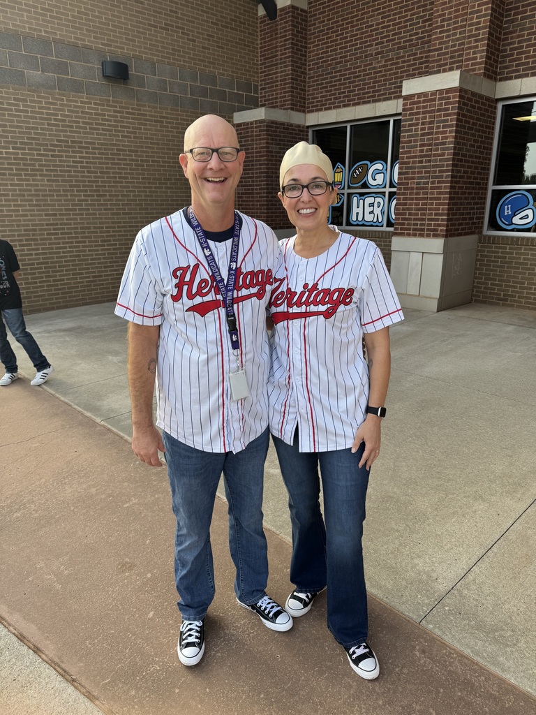 Two people in matching outfits one in a bald cap