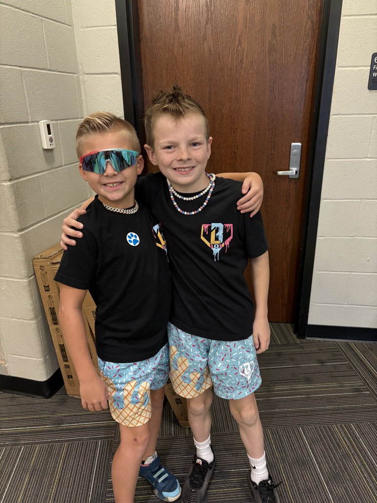 Two boys in matching outfits smiling