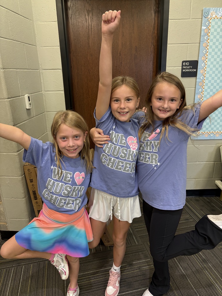 Three girls in matching outfits smiling