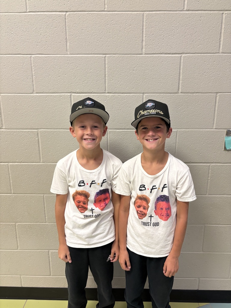 Two boys in matching outfits smiling