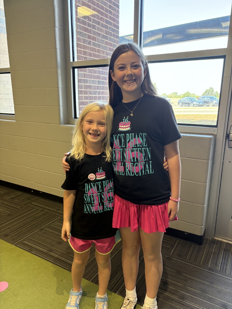 Two girls in matching outfits smiling