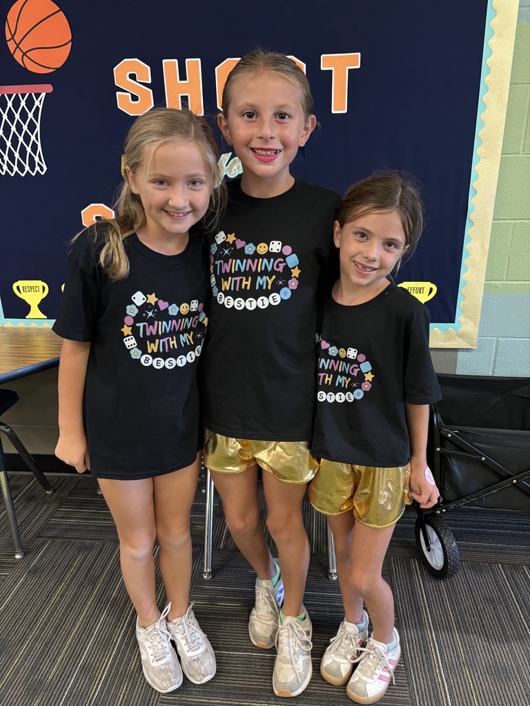 Three girls in matching outfits smiling