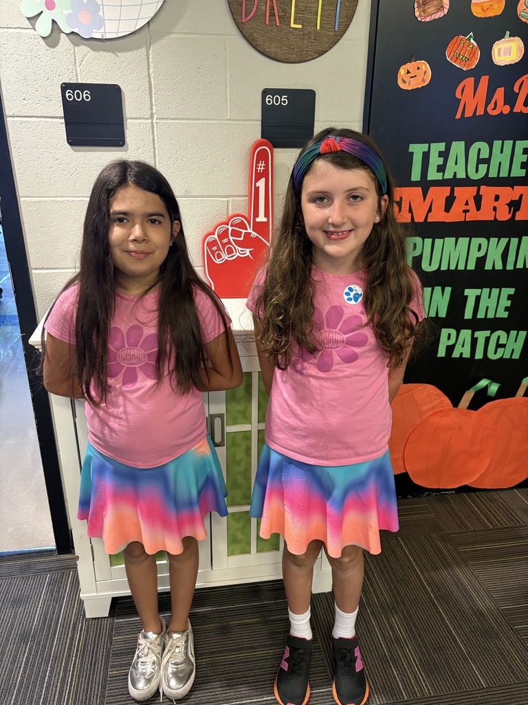 Two girls in matching outfits smiling