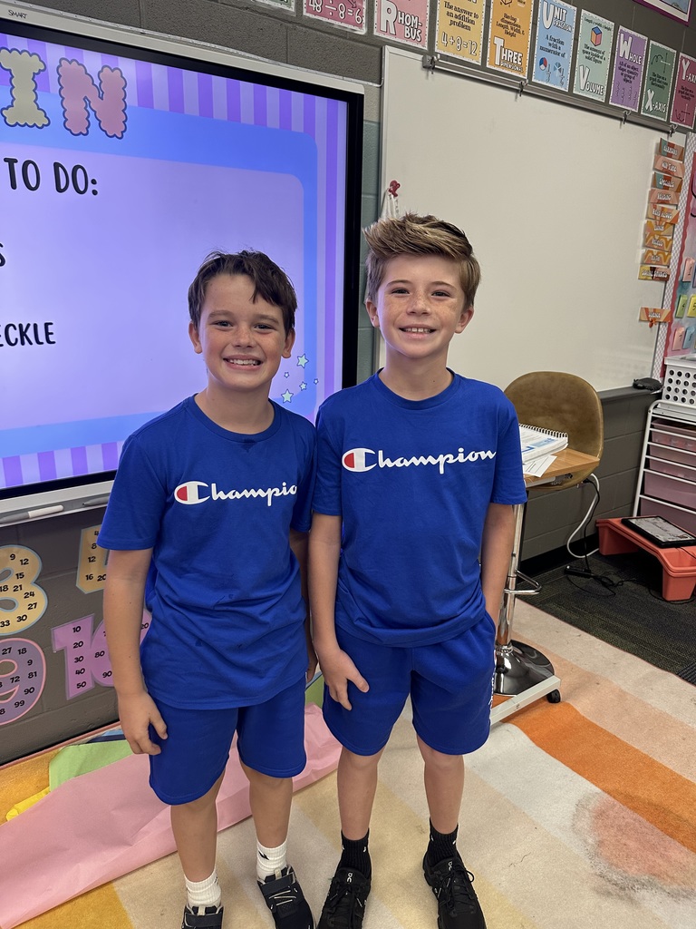 Two boys smiling wearing matching outfits
